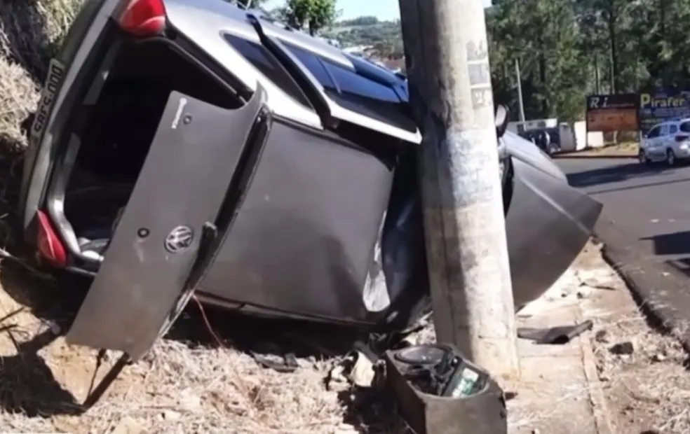 Carro fica preso entre poste e barranco após capotar em Piraju
